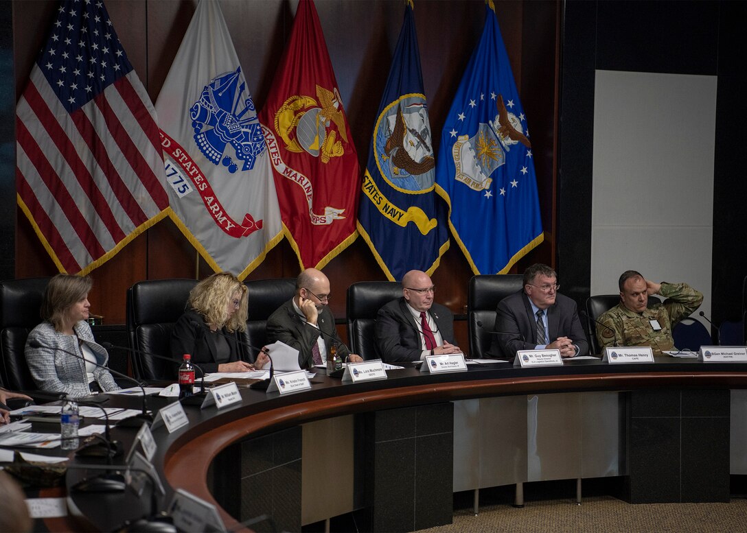 Two women and four men at table during the 13th Cost Summit.