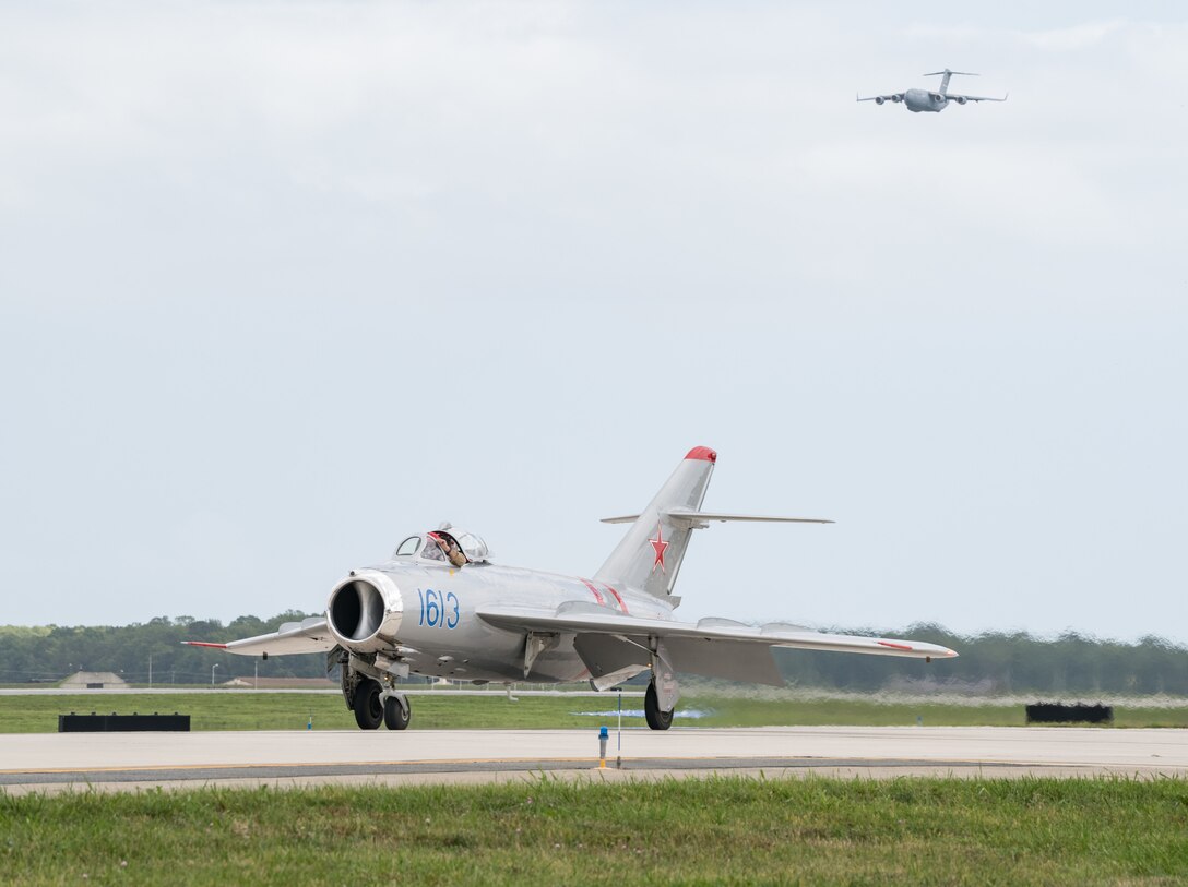 A MiG-17 taxis as a C-17 Globemaster III comes in for a low pass during the 2019 Thunder Over Dover Air Show Sept. 14, 2019, at Dover Air Force Base, Del.