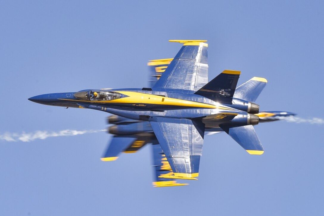 The U.S. Navy Flight Demonstration Squadron, the Blue Angels, solo pilots perform the knife-edge pass maneuver during the 2019 Lemoore Air Show.