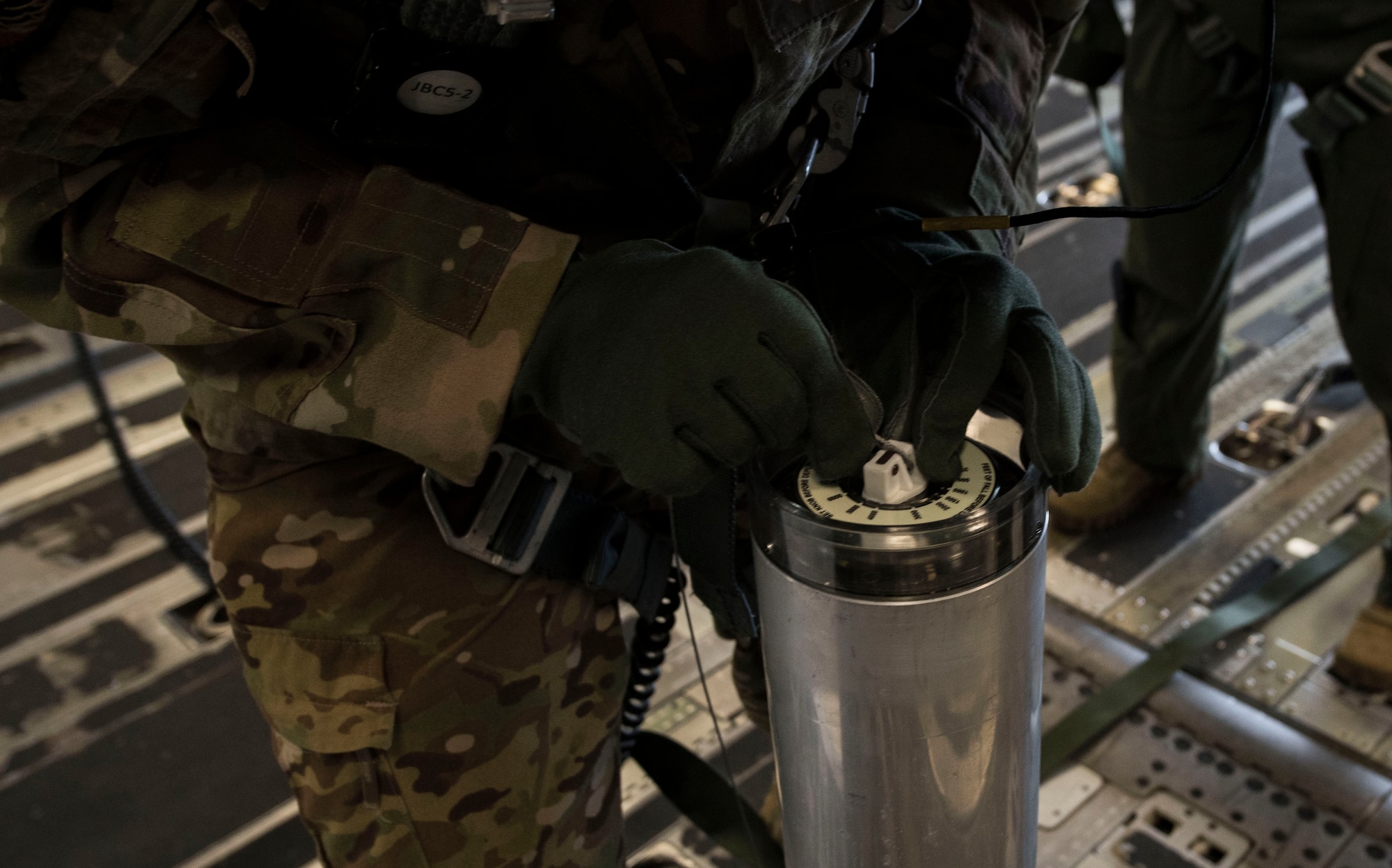 Chief Master Sgt. Donald Rouse, a loadmaster with the 39th Rescue Squadron, instructs test participants on how to properly prepare an illumination flare onboard a C-17 Globemaster III from Joint Base Charleston during Air Mobility Command Test and Evaluation Squadron’s assessment of tactics, techniques and procedures for astronaut rescue and recovery efforts Jan. 22, 2020, off the coast of Florida near Patrick Air Force Base.