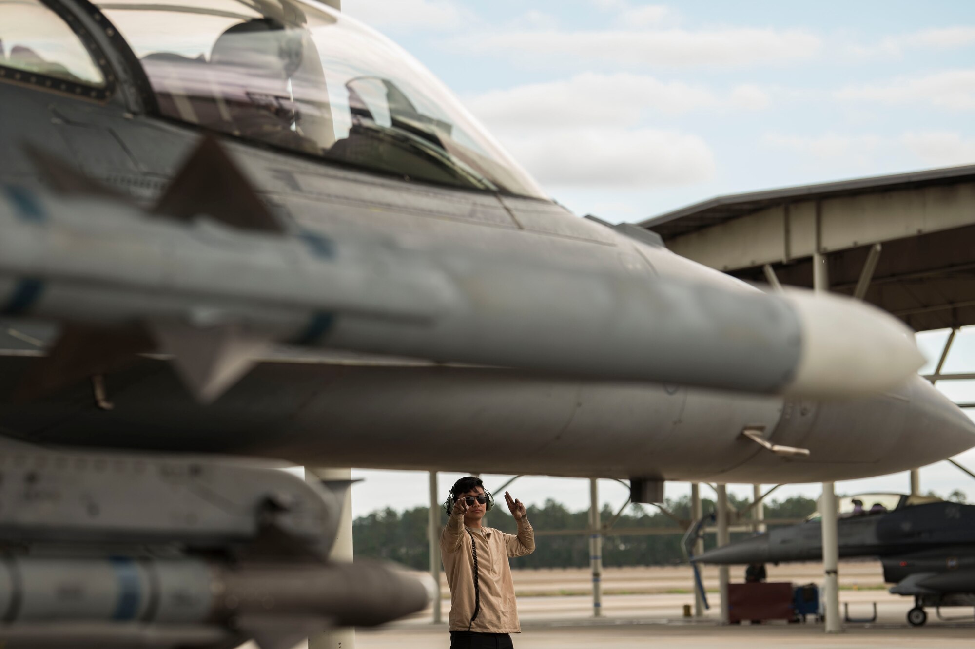 U.S. Air Force Airman 1st Class Joel Borja, 55th Aircraft Maintenance Unit dedicated crew chief, marshals a jet at Shaw Air Force Base, South Carolina, Jan. 15, 2020.