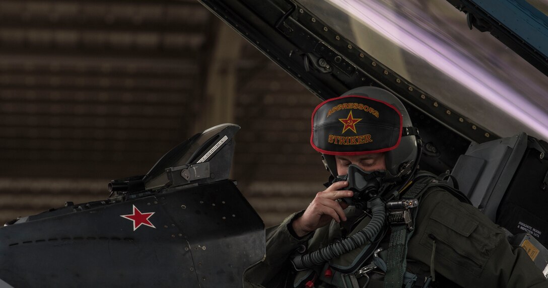 A U.S. Air Force pilot assigned to 64th Aggressor Squadron (AGS) fastens his helmet at Shaw Air Force Base (AFB), South Carolina, Jan. 15, 2020.