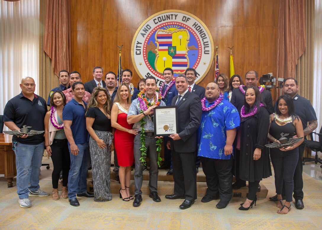 Jose “Pep” Tablada III, deputy assistant chief of staff of the Operations, Exercises and Engagement Division, U.S. Marine Corps Forces, Pacific (center), gathers with family and city council members after being awarded a certificate honoring his work in the community at City Hall, Honolulu, Hawaii, Jan. 29, 2020. Tablada received the certificate in recognition for his service and dedication to the Marine Reconnaissance Foundation, a foundation that provides support to active duty, former or retired members of the Marine Reconnaissance community and their families. (U.S. Marine Corps Photo by Lance Cpl. Sasha Pierre-Louis)
