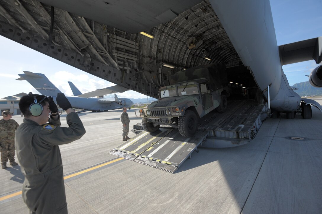 A U.S. Army Reserve HMMWV is offloaded from an Air Force C-17 Globemaster III during exercise Patriot Palm at Marine Corps Base Hawaii, Jan. 30, 2020.  The exercise involved specialists from the Air Force Reserve, Marine Corps, Army, Coast Guard, and civil authorities who practiced their disaster response capabilities.  (U.S. Air Force photo by Capt. Justin Clark)