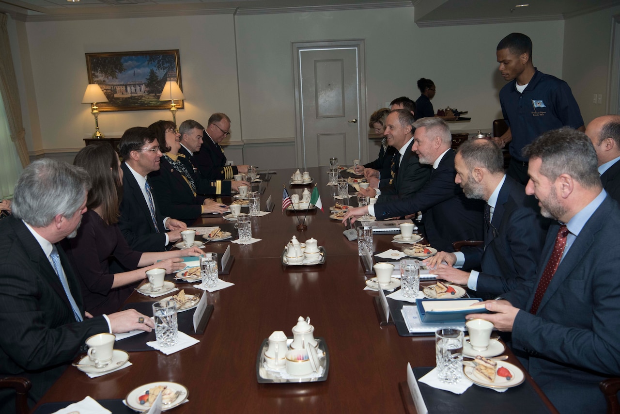 Several men sit at a conference table.