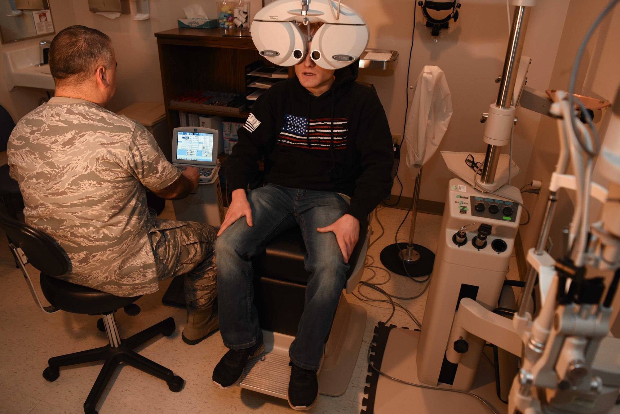 Maj. (Dr.) Gerardo Robles-Morales, 22nd Operational Medical Readiness Squadron optometry flight commander, examines the eyesight of Senior Airman Mitchel Delfosse, 22nd Aircraft Maintenance Squadron electrical environmental system journeyman, using a phoropter Jan. 30, 2020, at McConnell Air Force Base, Kansas. The phoropter allows the optometrist to get the patient’s sight as close to 20/20 as possible. (U.S. Air Force photo by Airman 1st Class Alexi Bosarge)