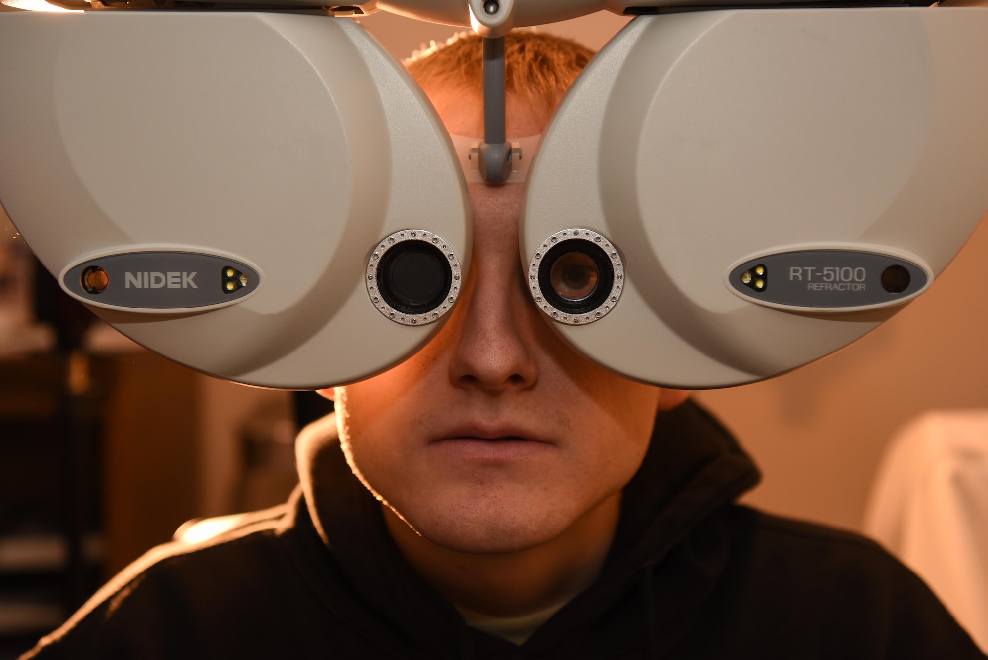 Senior Airman Mitchel Delfosse, 22nd Aircraft Maintenance Squadron electrical environmental system journeyman, looks through a phoropter Jan. 30, 2020, at McConnell Air Force Base, Kansas. The phoropter is used to test different lenses to determine the individual’s eyeglass prescription. (U.S. Air Force photo by Airman 1st Class Alexi Bosarge)