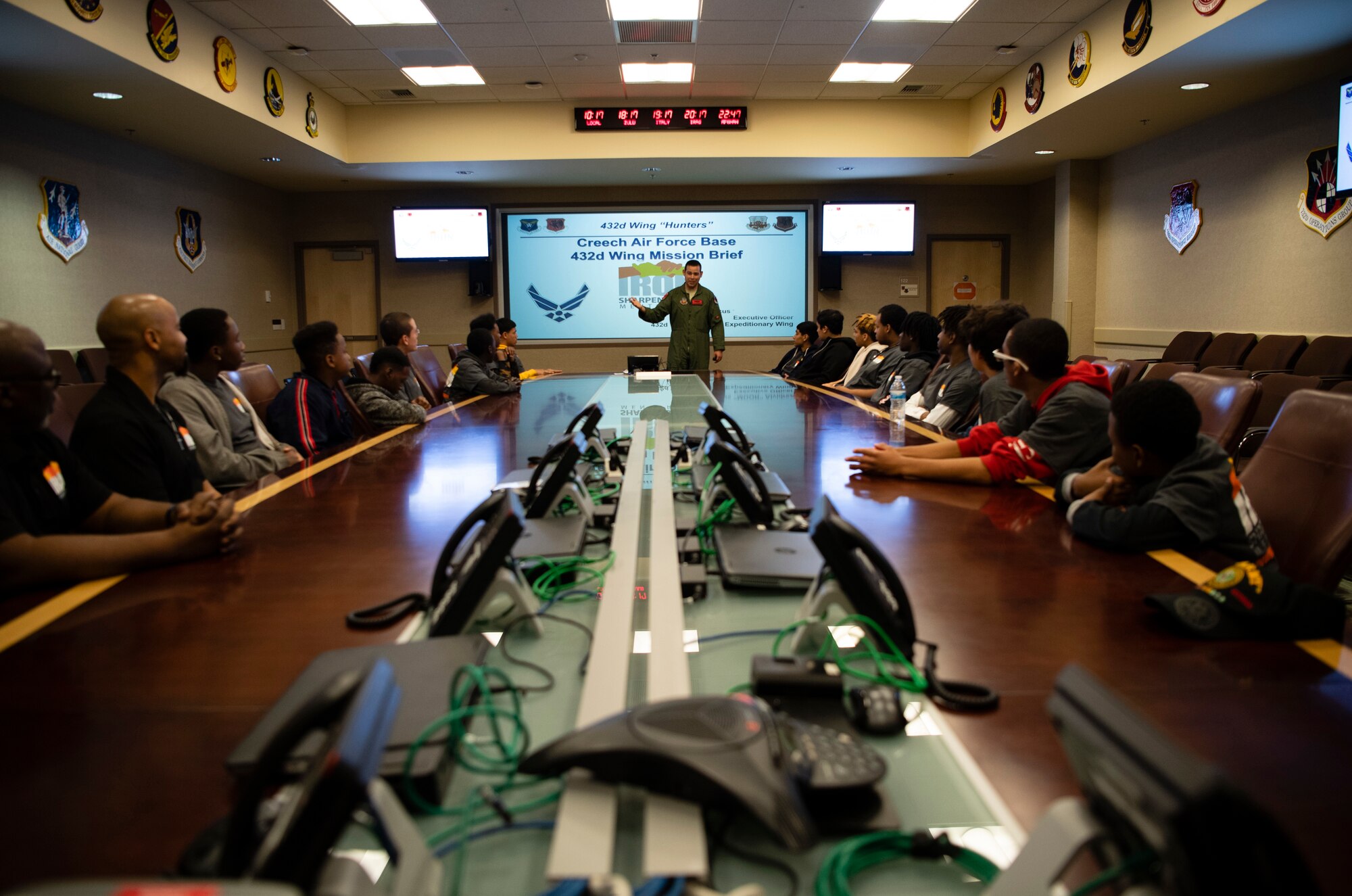Capt. Marcus, 432nd Wing executive officer, gives Iron Sharpens Iron Mentoring youth a mission brief during their visit to Creech Air Force Base, Nevada, Jan. 25, 2020