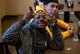 An Iron Sharpens Iron Mentoring youth displays the U.S. Air Force challenge coins he received during a mentoring event at Creech Air Force Base