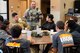 Staff Sgt. Cory, 432nd Security Forces Squadron defender, speaks with Iron Sharpens Iron Mentoring youth during their visit to Creech Air Force Base