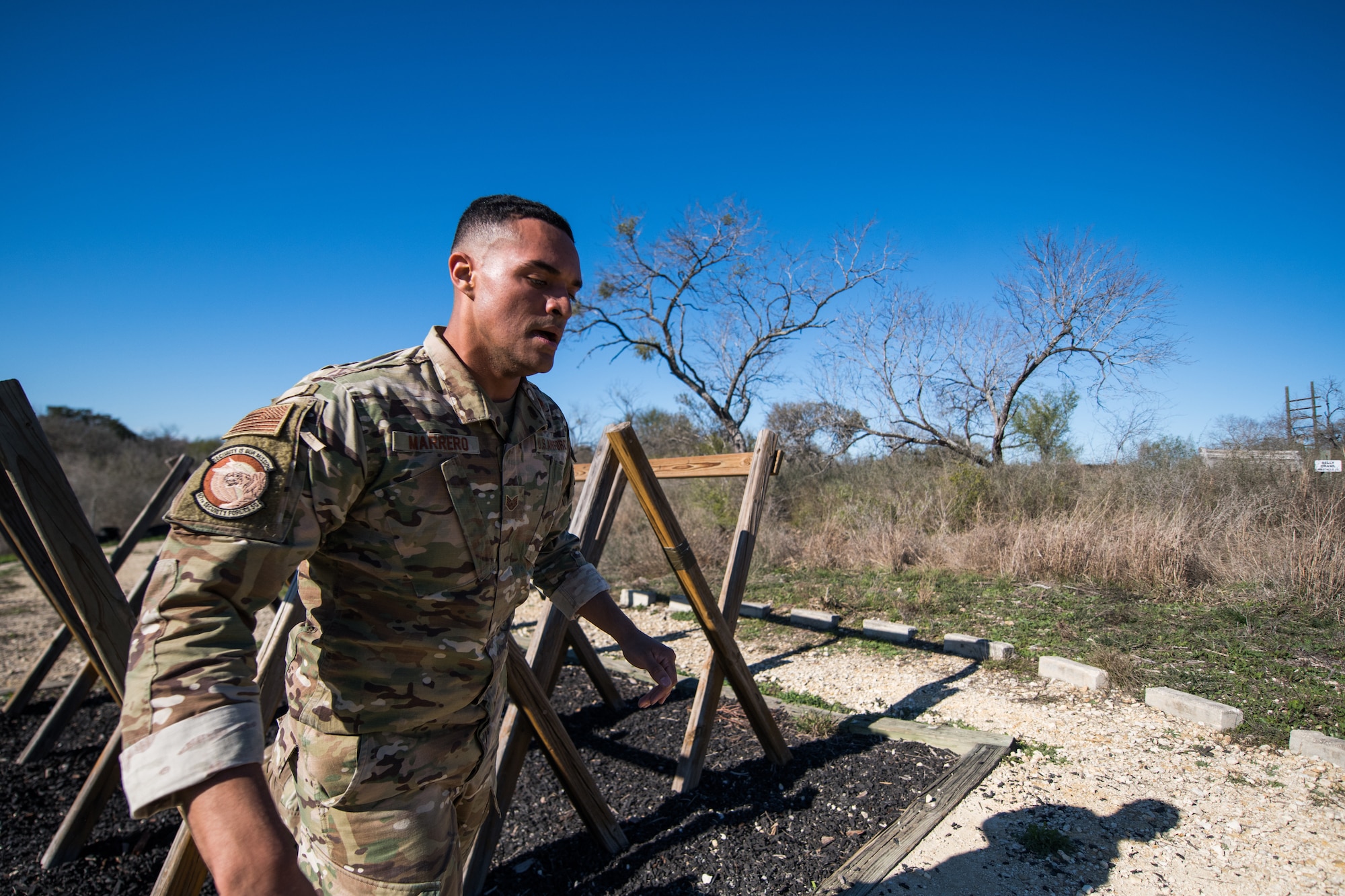 U.S. Air Force Staff Sgt. Richard Marrero, 97th Security Forces Squadron, Altus Air Force Base, Okla., takes part in the obstacle course portion of the Air Education and Training Command Defender Challenge team tryout at Joint Base San Antonio-Medina Annex, Texas, Jan. 29, 2020. The five-day selection camp includes a physical fitness test, M-9 and M-4 weapons firing, the alpha warrior obstacle course, a ruck march and also includes a military working dog tryout as well. A total of 27 Airmen, including five MWD handlers and their canine partners, were invited to tryout for the team. The seven selectees to the AETC team will represent the First Command at the career field’s world-wide competition that will be held at JBSA-Camp Bullis in May 2020. (U.S. Air Force photo by Sarayuth Pinthong)