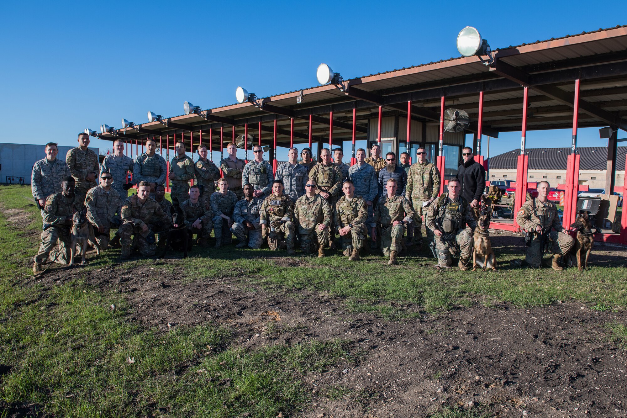 U.S. Air Force Security Forces Airmen pose for a group photo before the firing range portion of the Air Education and Training Command Defender Challenge team tryout at Joint Base San Antonio-Medina Annex, Texas, Jan. 29, 2020. The five-day selection camp includes a physical fitness test, M-9 and M-4 weapons firing, the alpha warrior obstacle course, a ruck march and also includes a military working dog tryout as well. A total of 27 Airmen, including five MWD handlers and their canine partners, were invited to tryout for the team. The seven selectees to the AETC team will represent the First Command at the career field’s world-wide competition that will be held at JBSA-Camp Bullis in May 2020. (U.S. Air Force photo by Sarayuth Pinthong)