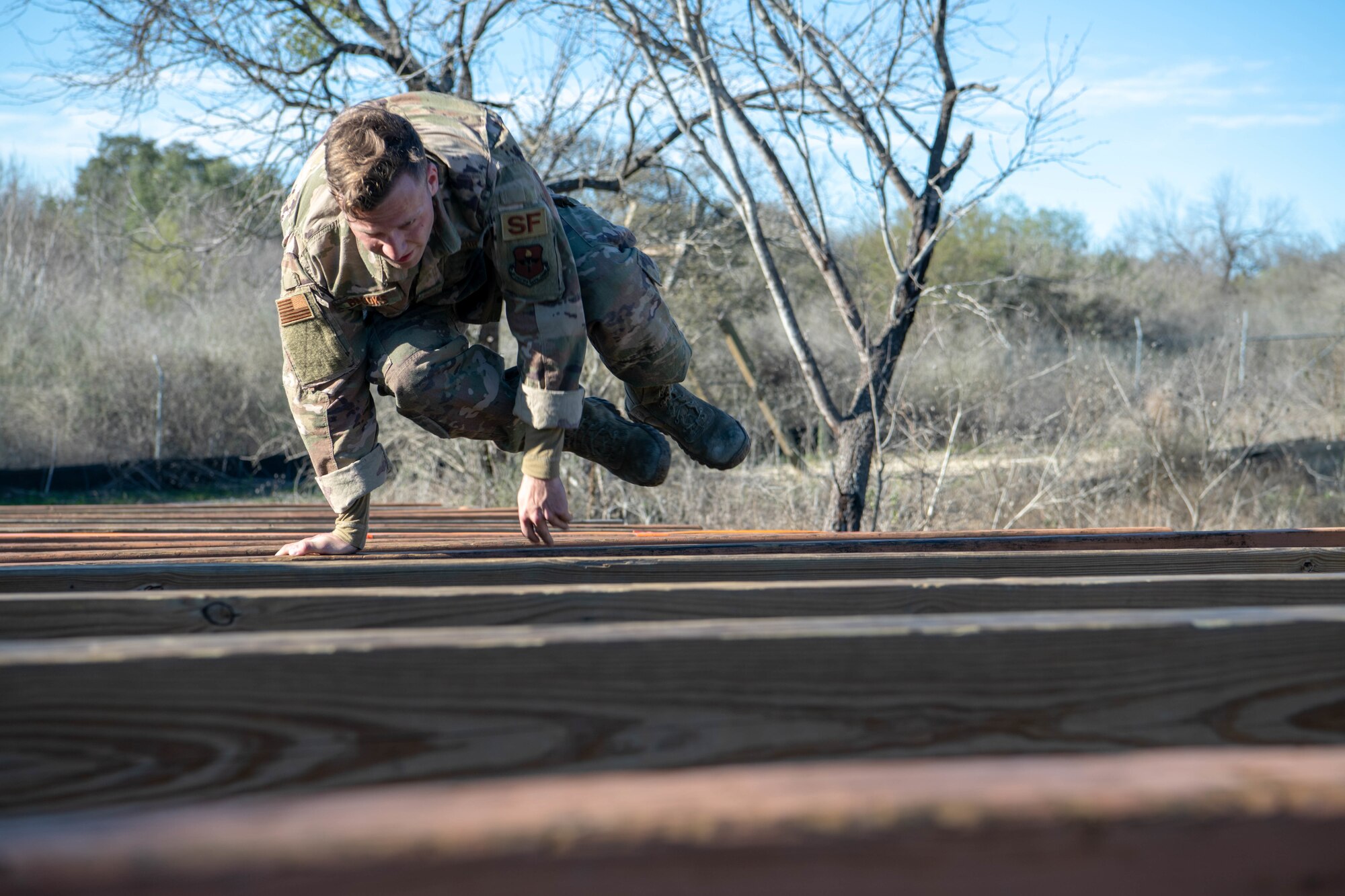 U.S. Air Force Senior Airman Matthew Brooks, 81st Security Forces Squadron military working dog handler, Keesler Air Force Base, Miss., takes part in the obstacle course portion of the Air Education and Training Command Defender Challenge team tryout at Joint Base San Antonio-Medina Annex, Texas, Jan. 29, 2020. The five-day selection camp includes a physical fitness test, M-9 and M-4 weapons firing, the alpha warrior obstacle course, a ruck march and also includes a military working dog tryout as well. A total of 27 Airmen, including five MWD handlers and their canine partners, were invited to tryout for the team. The seven selectees to the AETC team will represent the First Command at the career field’s world-wide competition that will be held at JBSA-Camp Bullis in May 2020. (U.S. Air Force photo by Christopher Campbell)