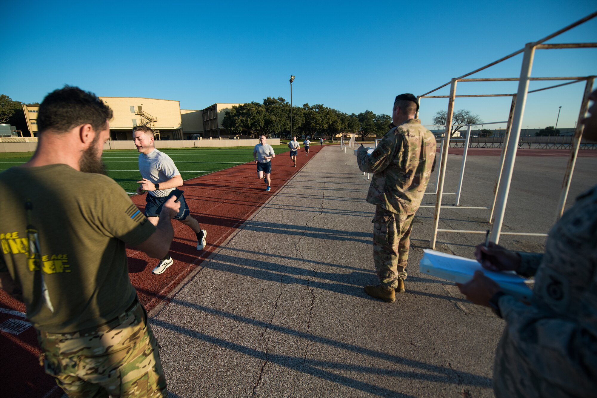 U.S. Air Force Security Forces Airmen take part in the run portion of a physical fitness test as the opening day of the Air Education and Training Command Defender Challenge team tryout at Joint Base San Antonio-Lackland, Texas, Jan. 27, 2020. The five-day selection camp includes a physical fitness test, M-9 and M-4 weapons firing, the alpha warrior obstacle course, a ruck march and also includes a military working dog tryout as well. A total of 27 Airmen, including five MWD handlers and their canine partners, were invited to tryout for the team. The seven selectees to the AETC team will represent the First Command at the career field’s world-wide competition that will be held at JBSA-Camp Bullis in May 2020. (U.S. Air Force photo by Sarayuth Pinthong)