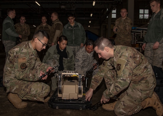 Airmen from the 35th Fighter Wing disassemble a communication flyaway kit at Misawa Air Base, Japan, Jan. 29, 2020. The CFK is a network used to connect to a satellite to help provide people with communications wherever they are. Multi-Domain Airman training encompasses the necessary skills, knowledge and experience to successfully generate combat power in an austere and expeditionary battlespace. (U.S. Air Force photo by Airman 1st Class China M. Shock)