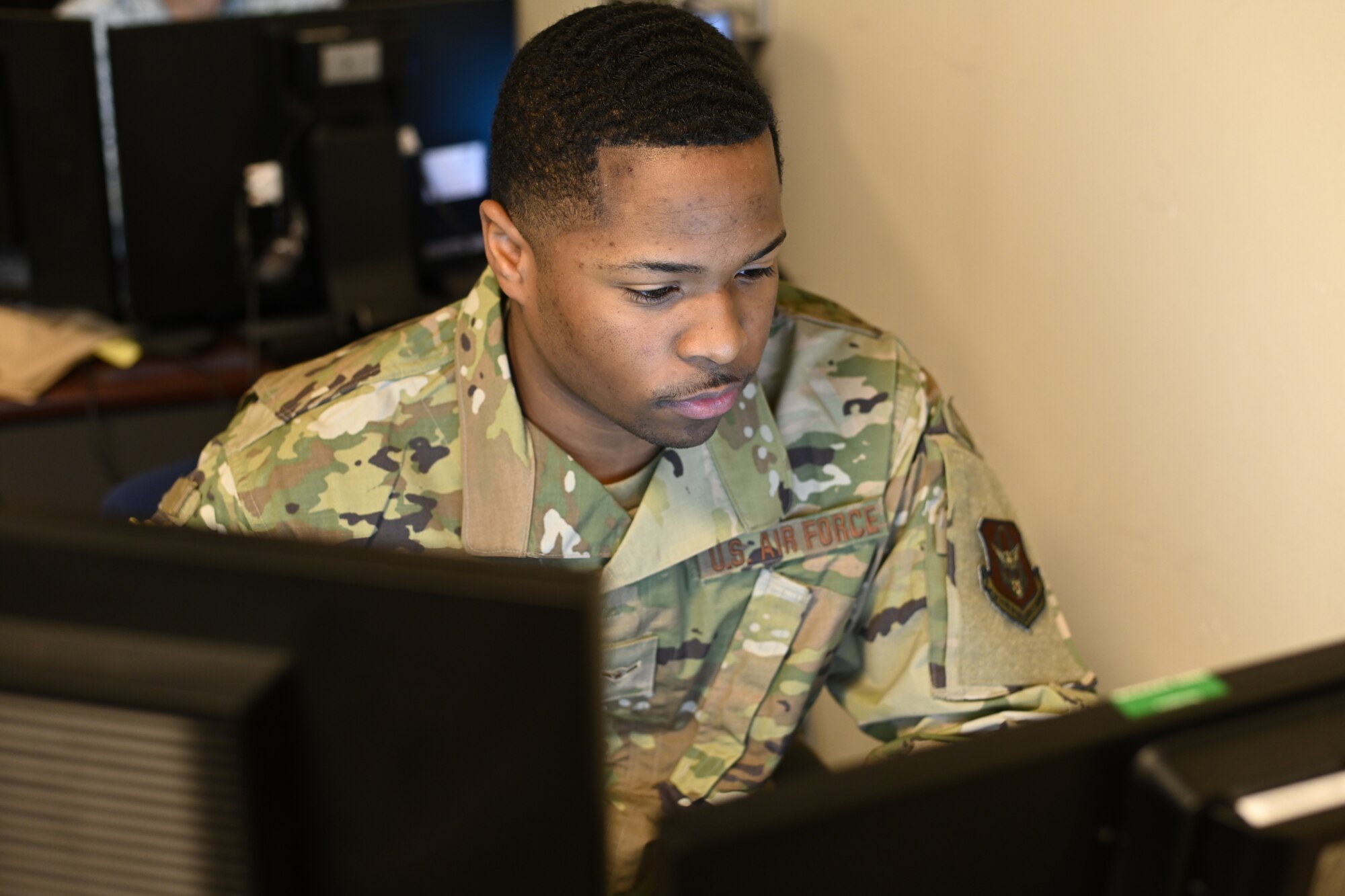 Photo of Airman working at computer.