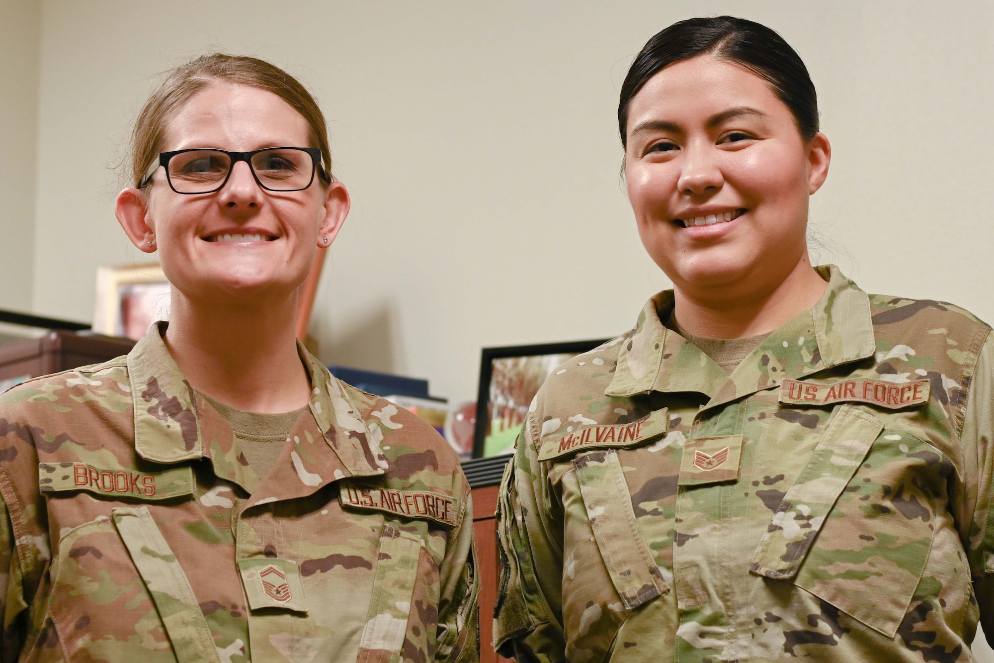 Photo of two Airman smiling.
