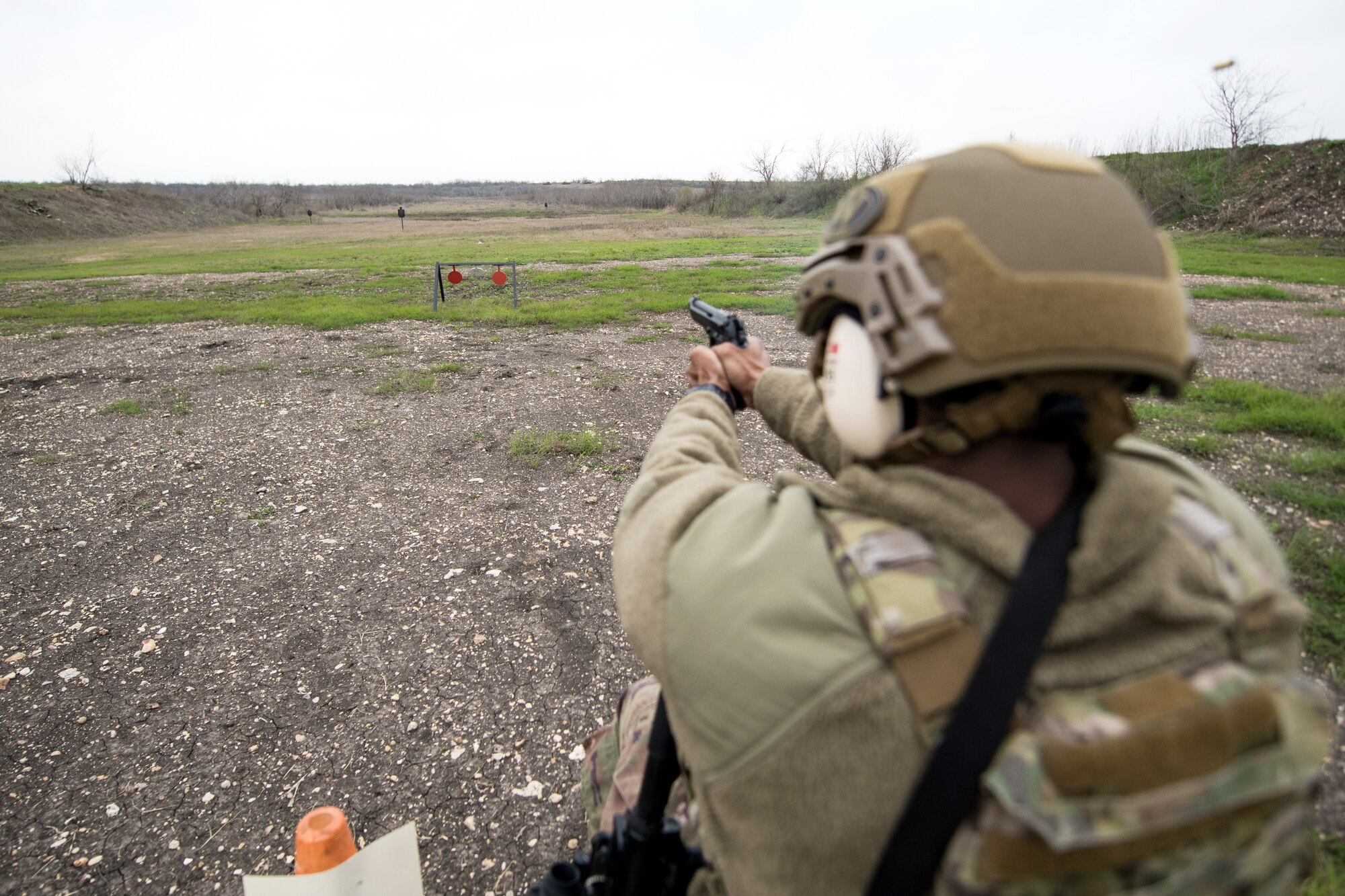 An U.S. Air Force Security Forces Airman takes part in the firing range portion of the Air Education and Training Command Defender Challenge team tryout at Joint Base San Antonio-Medina Annex, Texas, Jan. 30, 2020. The five-day selection camp includes a physical fitness test, M-9 and M-4 weapons firing, the alpha warrior obstacle course, a ruck march and also includes a military working dog tryout as well. A total of 27 Airmen, including five MWD handlers and their canine partners, were invited to tryout for the team. The seven selectees to the AETC team will represent the First Command at the career field’s world-wide competition that will be held at JBSA-Camp Bullis in May 2020. (U.S. Air Force photo by Sarayuth Pinthong)