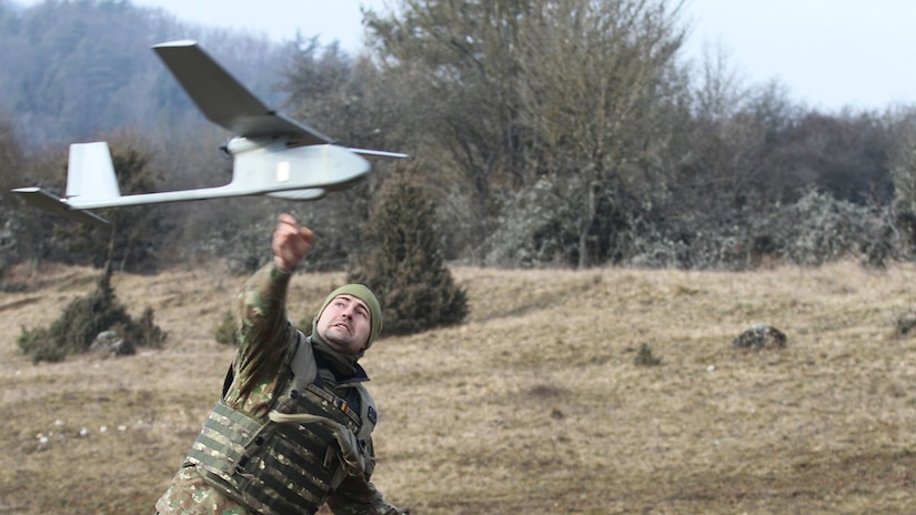 A soldier releases a drone.