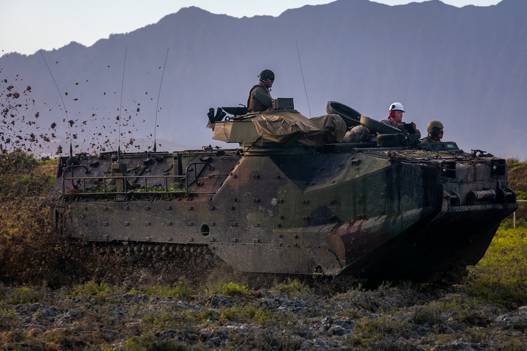 U.S. Marines with Combat Assault Company (CAC), 3d Marine Regiment, clear vegetation with an amphibious assault vehicle (AAV) from the Nu'upia Ponds Wildlife Management Area during the 35th annual 'Mud Ops', Marine Corps Base Hawaii (MCBH), Jan. 29, 2020. The MCBH Environmental Compliance and Protection Department partnered with Combat Assault Company to utilize their AAVs in an effort to fight back against invasive plants and prepare plots of wetlands for local water fowl. (U.S. Marine Corps photo by Cpl. Matthew Kirk)