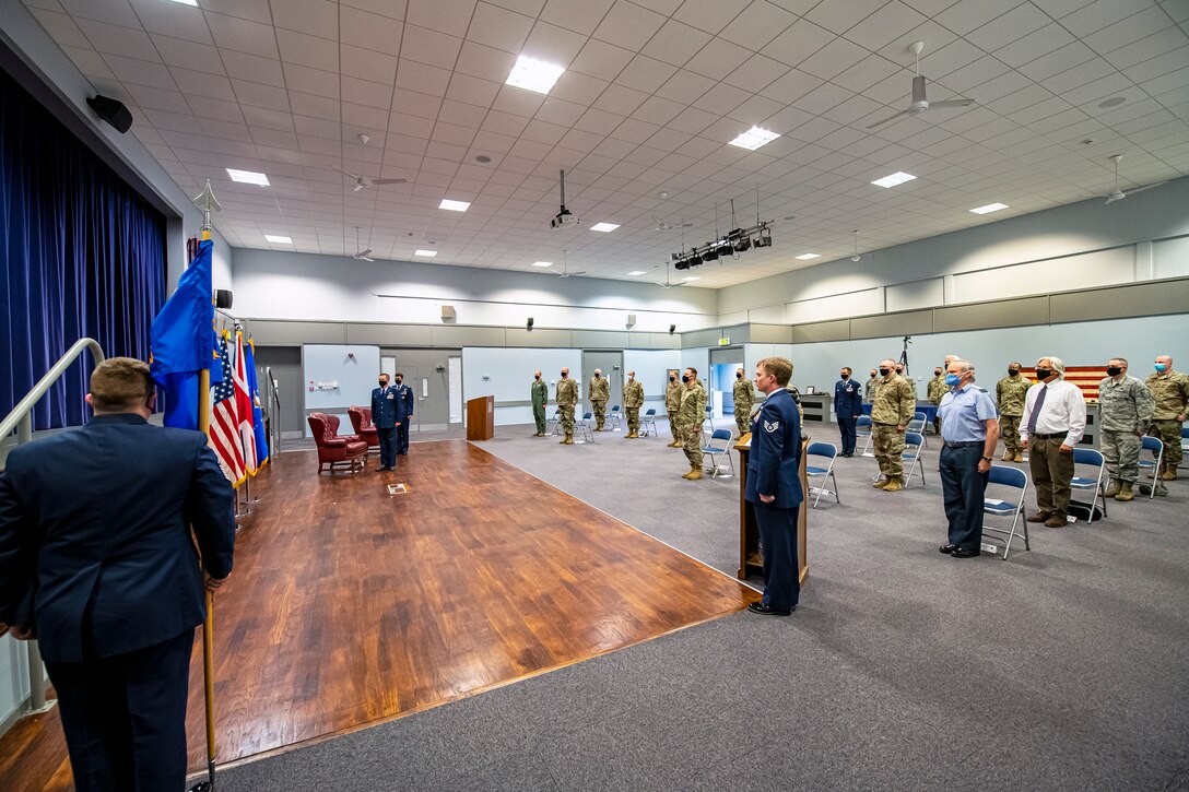 Airmen and guests from the 501st Combat Support Wing stand at attention, for the playing of the national anthem during the 422d Communications Squadron assumption of command ceremony, at RAF Croughton, England, June 30, 2020. An assumption of command is a military tradition that represents a formal assumption of a unit’s authority and responsibility by a commander. (U.S. Air Force photo by Senior Airman Eugene Oliver)