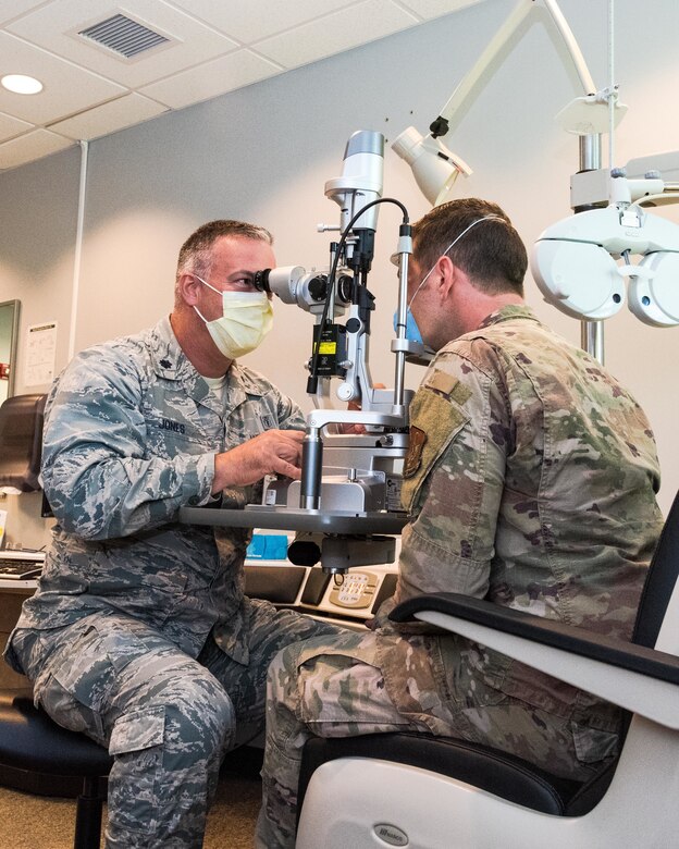 Air Force Reserve Lt. Col. Wayne Jones, 913th Aerospace Medicine Squadron optometrist, demonstrates eye examinations June 6, 2020, at Little Rock Air Force Base, Ark. Optometrists perform yearly eye exams to assess vision and identify eye disorders, ensuring deployment readiness for Airmen and the group. Individual medical readiness includes a number of regular medical examinations required for deployment readiness. (U.S. Air Force Reserve photo by Maj. Ashley Walker)