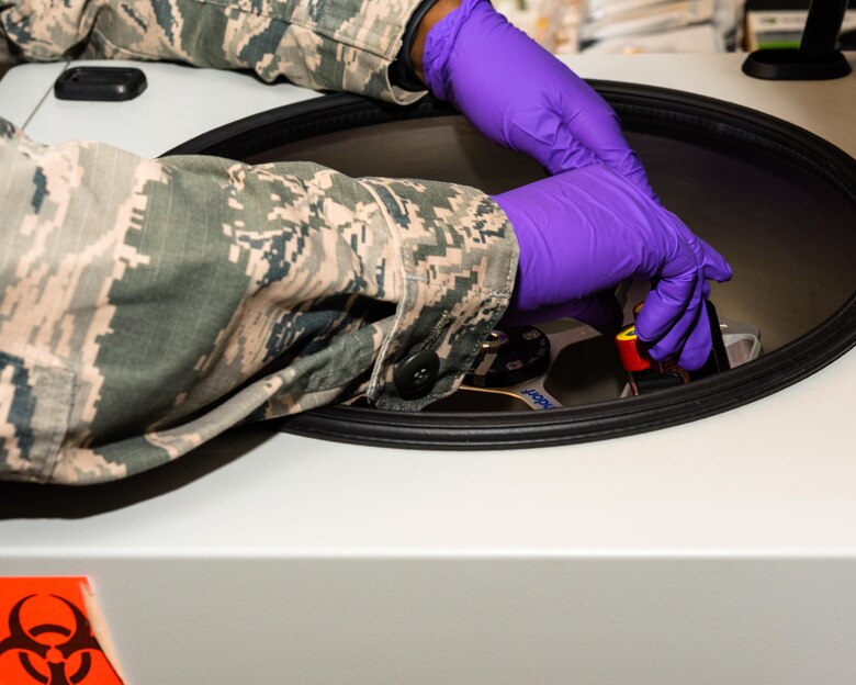 Air Force Reserve Senior Airman Jamie Scroggins, 913th Aerospace Medicine Squadron lab technician, places blood specimens into a centrifuge at Little Rock Air Force Base, Ark., June 6, 2020. While adhering to COVID-19 health protection procedures, Scroggins collected blood samples from Reservists who were due for annual medical examinations. Individual medical readiness includes a number of regular medical examinations required for deployment readiness. (U.S. Air Force Reserve photo by Maj. Ashley Walker)