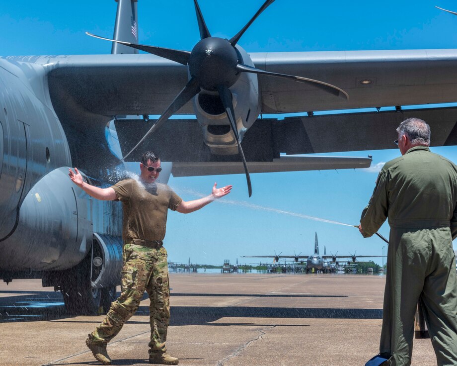 Man sprayed with water after stepping away from his final C-130J Super Hercules flight