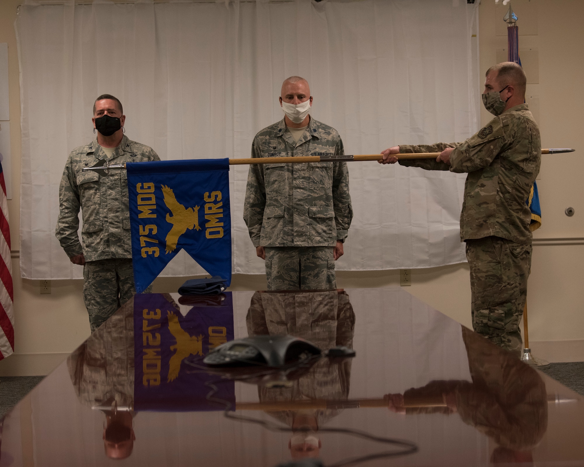 U.S. Air Force officer stand behind guidon