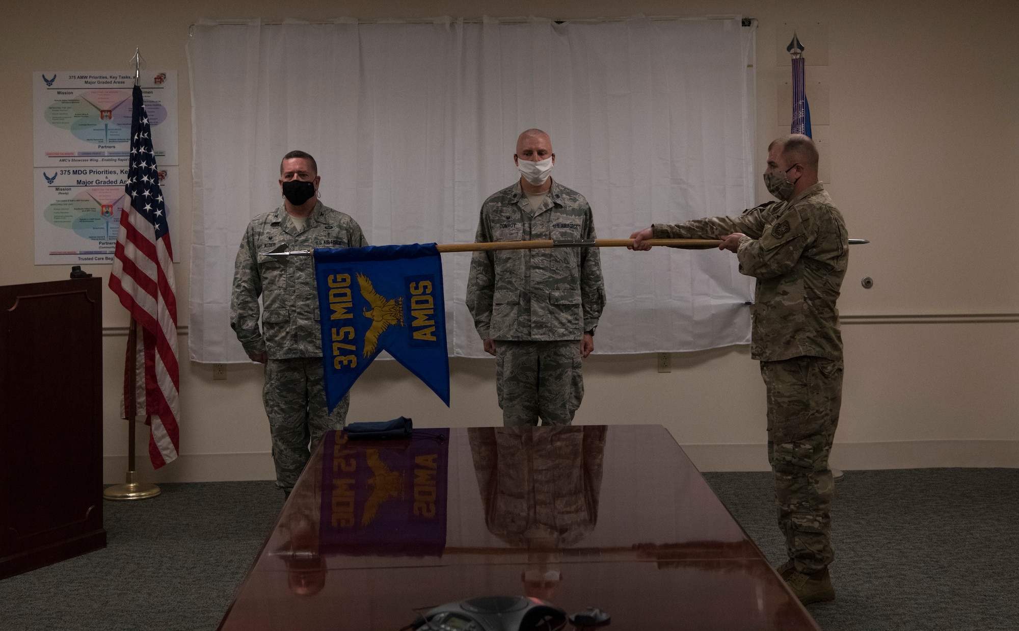 U.S Air Force officers stand behind guidon