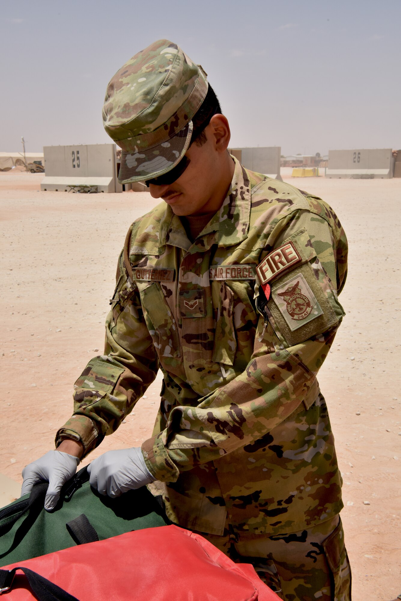 Medic Airmen from the 378th Expeditionary Medical Squadron train during a heat injury, rapid cool protocol exercise with firefighters from the 378th Expeditionary Civil Engineer Squadron at Prince Sultan Air Base, Kingdom of Saudi Arabia, July 1, 2020. Rapid response time to heat injuries is crucial for life-saving treatment for a patient. (U.S. Air Force photo by Master Sgt. Benjamin Wiseman)