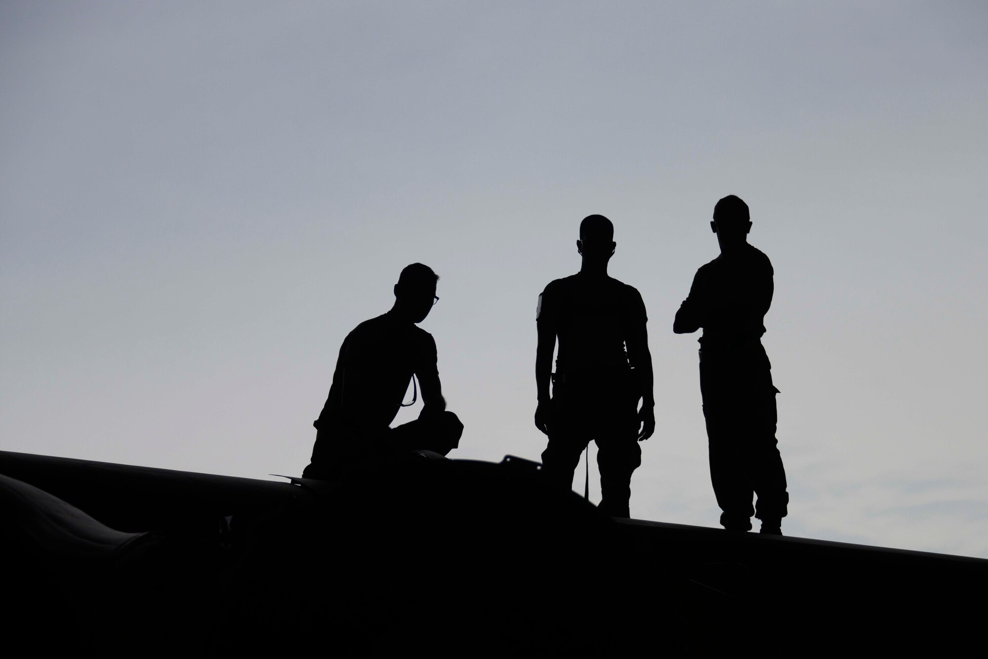 Photo of Airmen standing on wing of B-52