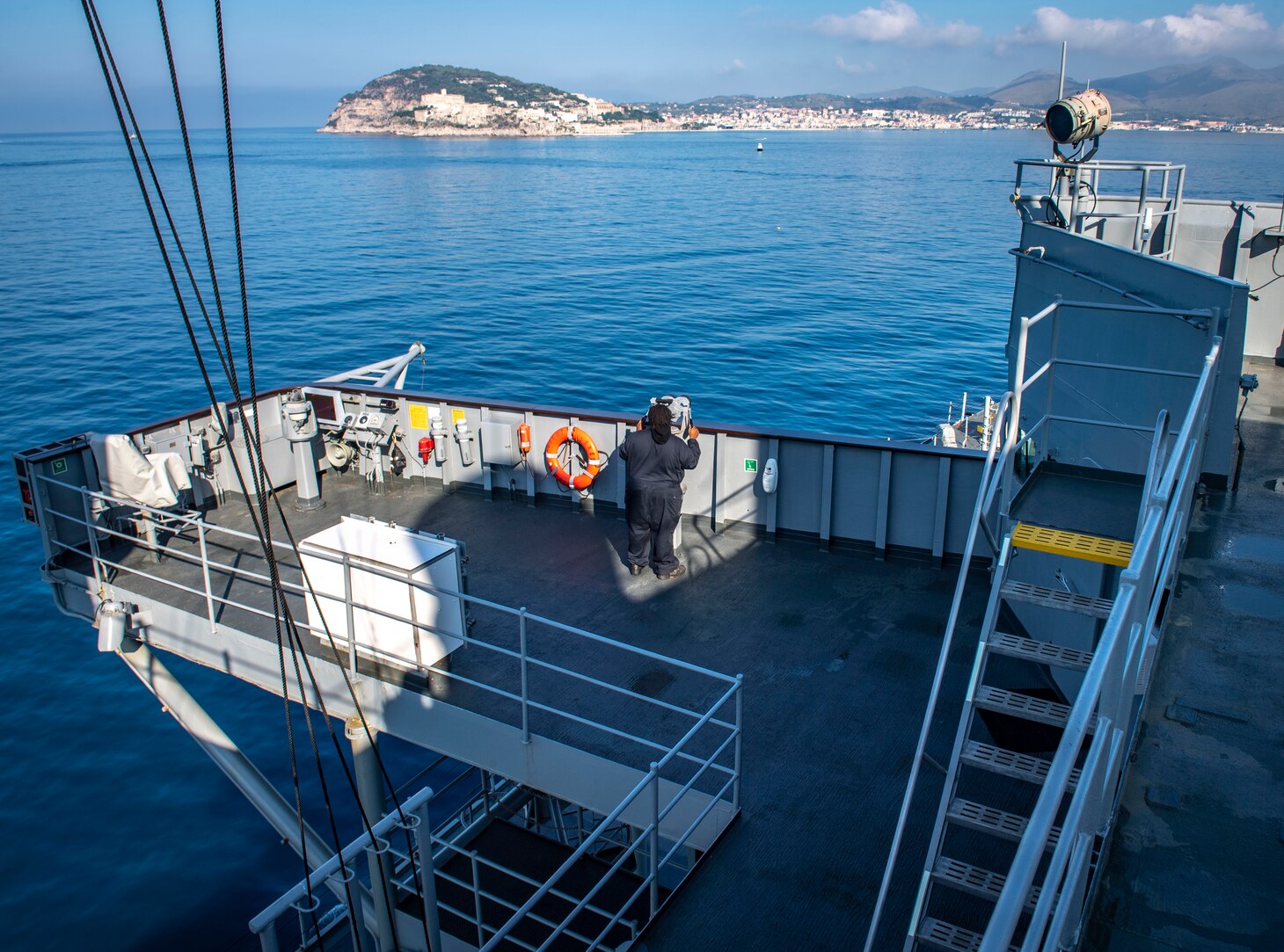200701-N-RG482-0099 GAETA, Italy (July 1, 2020) Civil service mariner Tim Murray, assigned to the Blue Ridge-class command and control ship USS Mount Whitney (LCC 20) stands watch on the port bridge wing as the ship arrives in Gaeta, Italy, July 1, 2020. Mount Whitney is the U.S. 6th Fleet flagship, homeported in Gaeta, Italy, and operates with a combined crew of U.S. Sailors and Military Sealift Command civil service mariners. (U.S. Navy photo by Mass Communication Specialist 1st Class Kyle Steckler)
