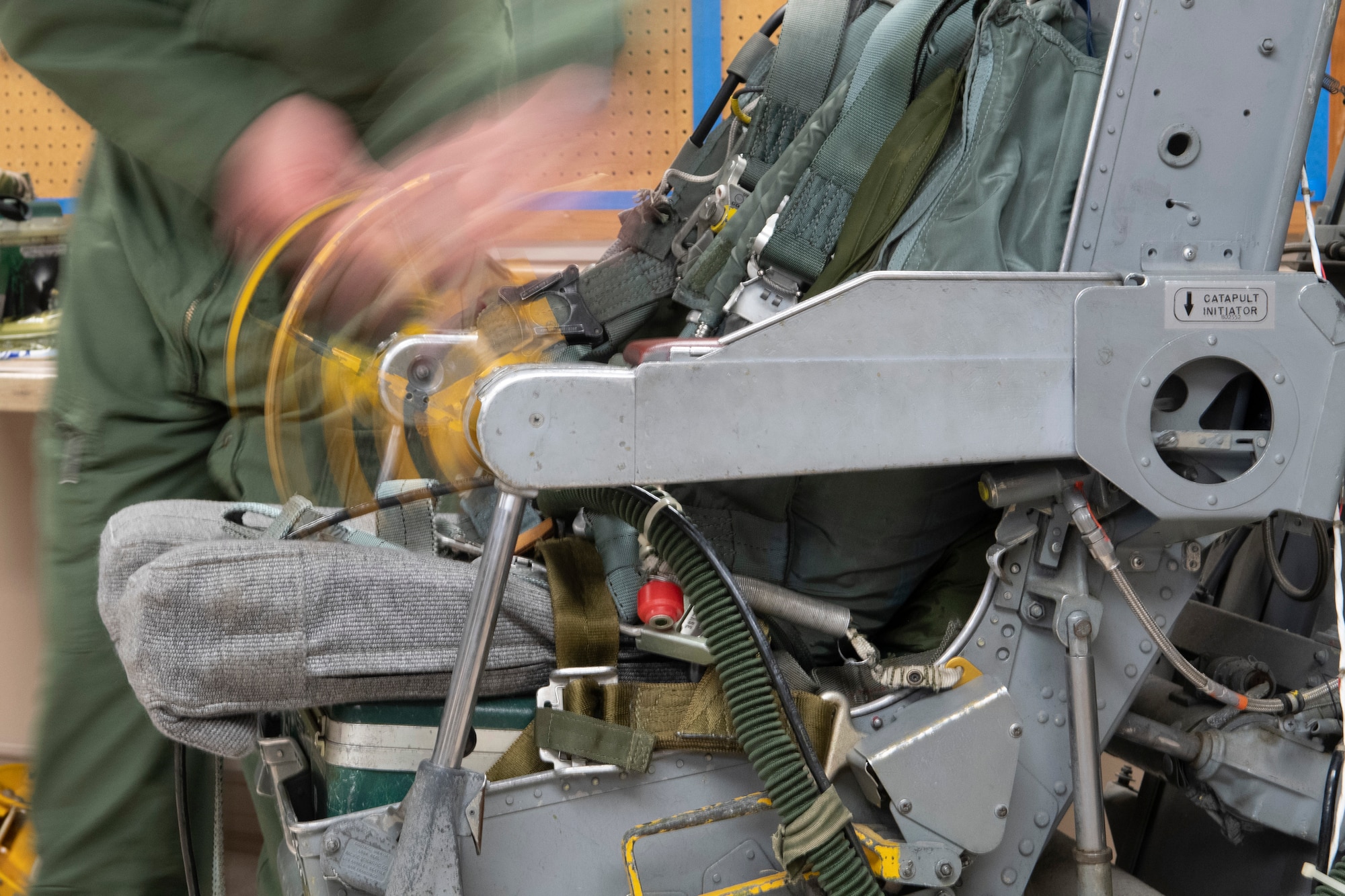 Photo of Airman working on ejection seat.
