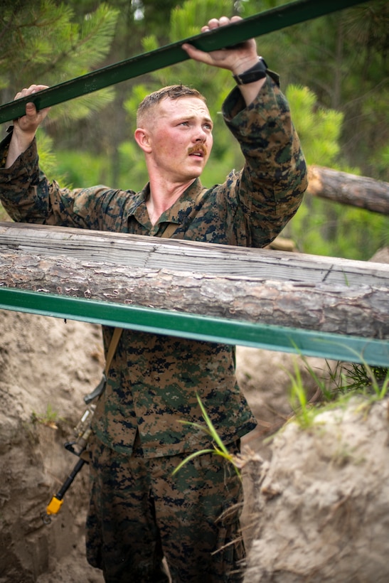 Sgt. Andrew Boyles, a combat engineer with Special Purpose Marine Air-Ground Task Force - Southern Command, sets up a fighting hole position during a field exercise at Camp Lejeune, North Carolina, June 9, 2020. The FEX provides the Marines and Sailors the opportunity to stay proficient with their equipment and refine their tactical skill sets. SPMAGTF-SC is poised to conduct crisis response, general engineering training and theater security cooperations alongside partner nation militaries in Latin America and the Caribbean. Boyles is a native of Eugene, Oregon. (U.S. Marine Corps photo by Sgt. Andy O. Martinez)