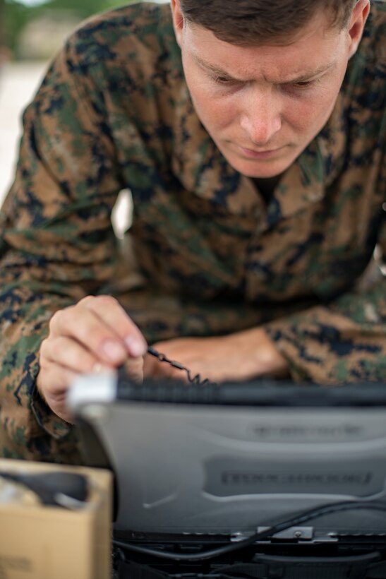 Cpl. Nicholas Whisenhunt, an engineer equipment operator with Special Purpose Marine Air-Ground Task Force - Southern Command, navigates a flight course for an RQ-11B Raven during a field exercise at Camp Lejeune, North Carolina, June 11, 2020. The FEX provides the Marines and Sailors the opportunity to stay proficient with their equipment and refine their tactical skill sets. SPMAGTF-SC is poised to conduct crisis response, general engineering training and theater security cooperations alongside partner nation militaries in Latin America and the Caribbean. Whisenhunt is a native of Keizer, Oregon. (U.S. Marine Corps photo by Sgt. Andy O. Martinez)