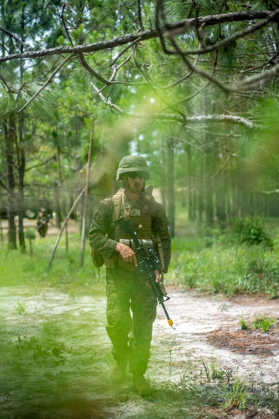 Cpl. Justin Huxley, a combat engineer with Special Purpose Marine Air-Ground Task Force - Southern Command, conducts a simulated patrol during a field exercise at Camp Lejeune, North Carolina, June 8, 2020. The FEX provides the Marines and Sailors the opportunity to stay proficient with their equipment and refine their tactical skill sets. SPMAGTF-SC is poised to conduct crisis response, general engineering training and theater security cooperations alongside partner nation militaries in Latin America and the Caribbean. Huxley is a native of Independence, Oregon. (U.S. Marine Corps photo by Sgt. Andy O. Martinez)