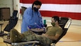Alaska Army National Guard Capt. James Tollefson, an operations plans officer with Joint Task Force-Alaska, donates blood at the Guard Armory on Joint Base Elmendorf-Richardson, May 26, 2020. Blood donation centers have been impacted by a lack of donors during the COVID-19 pandemic, while the need for blood, plasma and platelets continue to be critically needed for many medical services. (U.S. Army National Guard photo by Sgt. Seth LaCount/Released)