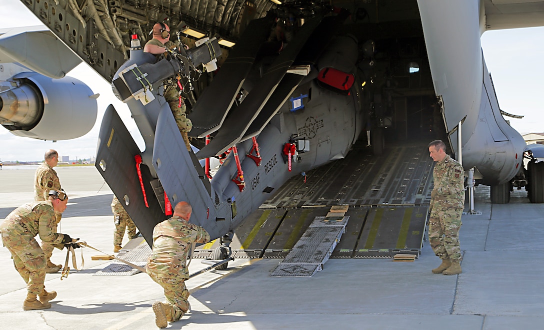 Alaska Air National Guard crew chiefs and pilots assigned to the 176th Wing load a Sikorsky MH-60G Pave Hawk helicopter onto their Boeing C-17 Globemaster III in preparation for a deployment June 3, 2020. The helicopters belong to the ANG's 212th Rescue Squadron assigned to the Wing that will be deploying in the coming months. (U.S. Army National Guard photo by Sgt. Seth LaCount/Released)