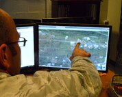 Senior Airman Matt, a geospatial analyst with the 118th Intelligence, Surveillance, and Reconnaissance Group based at Joint Base Berry Field in Nashville, Tenn., points to a damaged building in Puerto Rico following Hurricane Irma, September 15. The unit is currently tasked with supporting first responders during hurricane relief efforts.