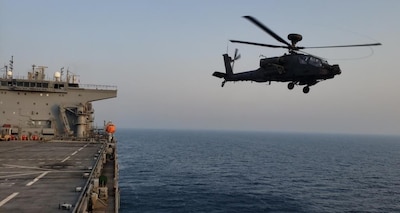 ARABIAN GULF (June. 25, 2020) A AH-64D Apache helicopter attached to the United Arab Emirates Joint Aviation Command, launches from the flight deck during flight operations aboard the expeditionary sea base USS Lewis B. Puller (ESB 3) June 25, 2020. Lewis B. Puller is deployed to the U.S. 5th Fleet area of operations in support of naval operations to ensure maritime stability and security in the Central Region, connecting the Mediterranean and Pacific through the Western Indian Ocean and three critical chokepoints to the free flow of global commerce. (U.S. Navy photo by Chief Logistics Specialist Thomas Joyce)