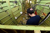 John Farhat, aircraft electrical mechanic III with Amentum, at the Corpus Christi Army Depot, Texas, installs arc 220 wiring for the UH-60L communications system inside the aircraft tail section. This is the first aircraft (8BZ32) to be painted using 100% class N (non-chromate) primers on the interior and exterior. Corpus Christi is setting the standard for both military and commercial industry to follow.  (Photo by Ervey Martinez)