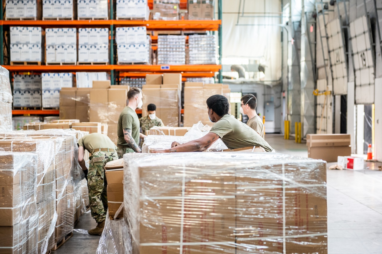 Soldiers prepare large boxes for delivery.