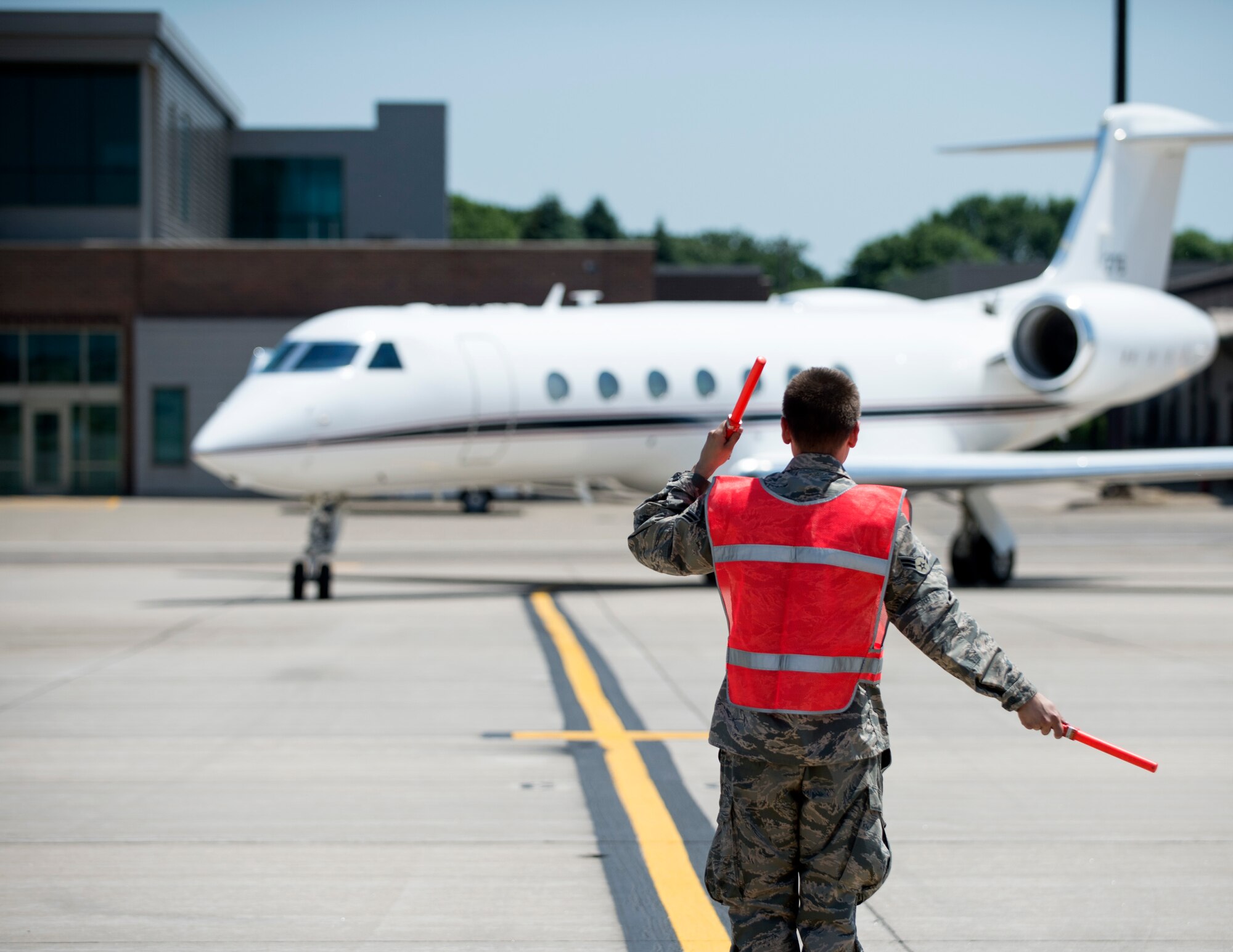 U.S. Air Force Airman from the 133rd Aircraft Maintenance Squadron marshals U.S. Air Force U.S. Air Force Gen. Joseph L. Lengyel, Chief of the National Guard Bureau, aircraft into position in St. Paul, Minn., June 17, 2020.