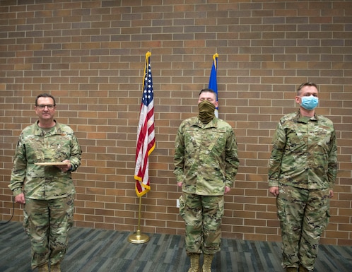 U.S. Air Force Tech. Sgt. Kyle Sovde, center, and Staff Sgt. Tyson Schnitker from the 133rd Medical Group were recognized by U.S. Air Force Gen. Joseph L. Lengyel, Chief of the National Guard Bureau, for their work during the COVID-19 and civil unrest State Active Duty assignments in St. Paul, Minn., June 17, 2020.