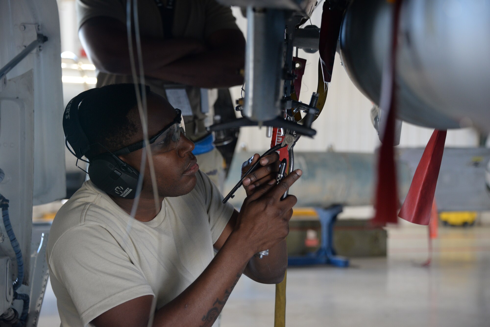 A photo of an Airman working on munitions