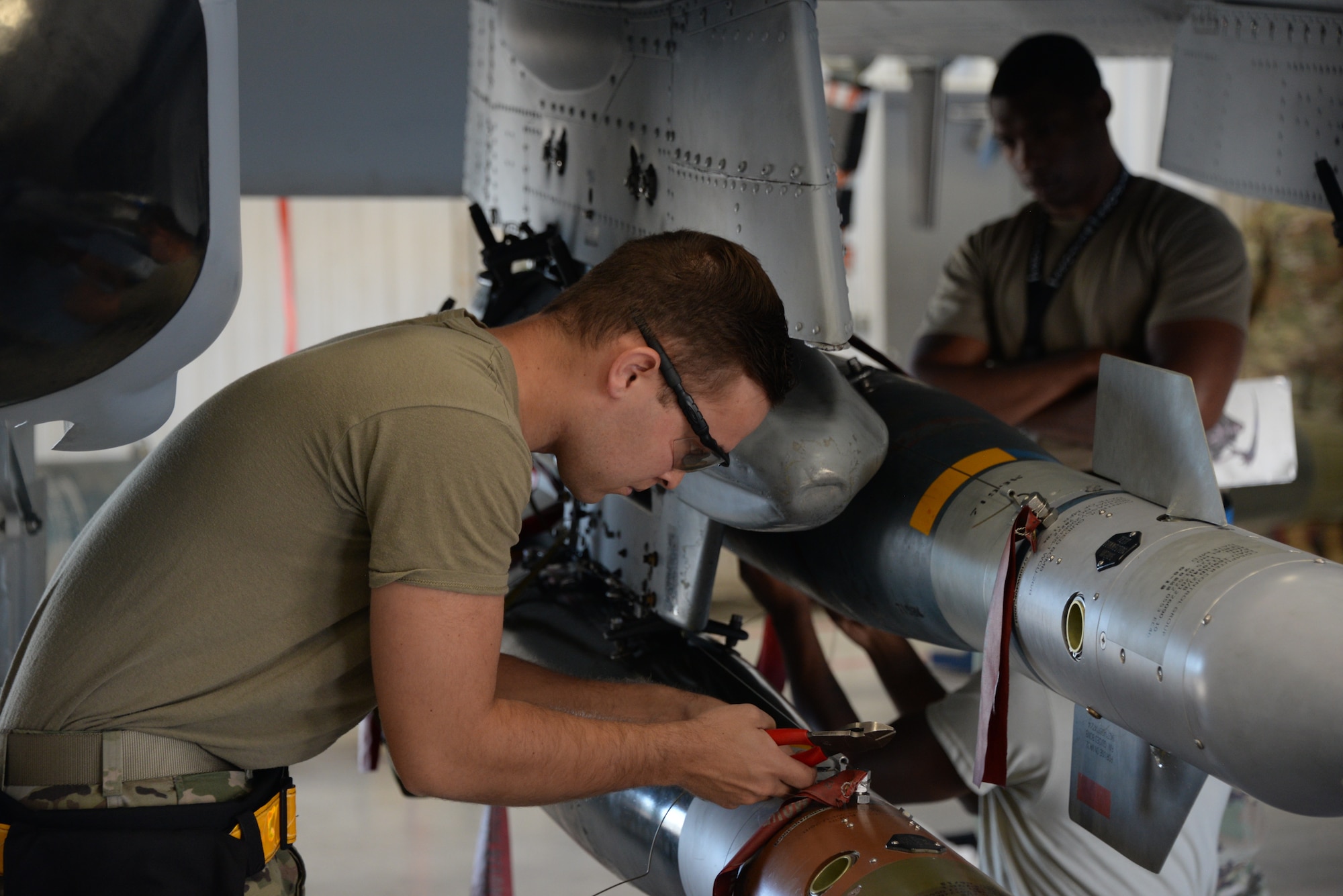 A photo of an Airman working on munitions