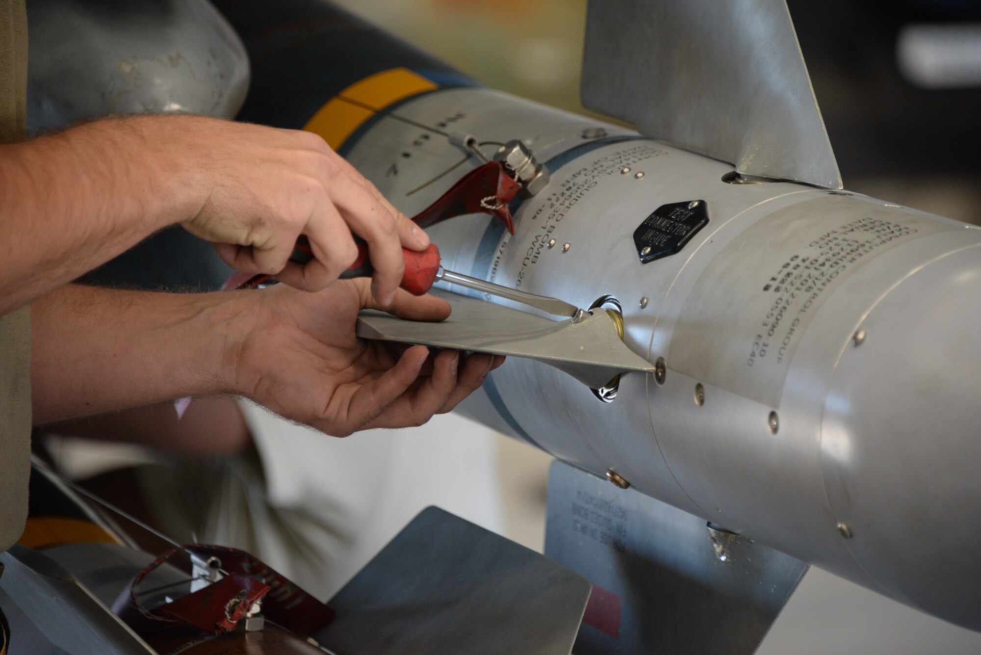 A photo of an Airman working on munitions