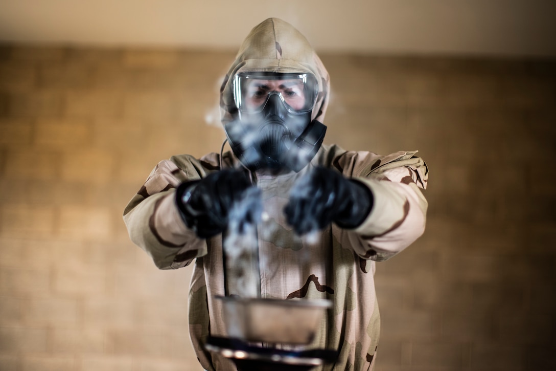 A U.S. Marine burns a non-lethal chlorobenzylidene malononitrile capsule during a gas chamber qualification at Marine Corps Base Camp Pendleton, Calif., June 19.