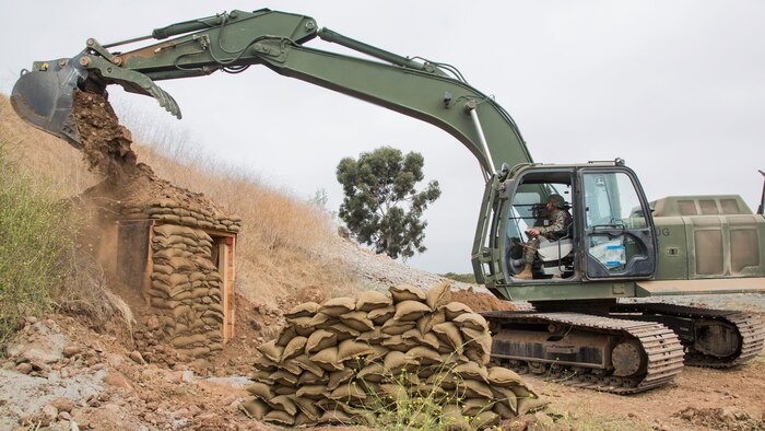 A U.S. Marine operates a 250G Hydraulic Excavator during the construction of a forward operating base at Marine Corps Air Station Miramar, Calif., June 24.
